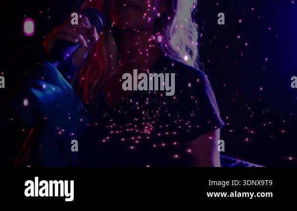 Performer gripping microphone triggers glowing particle overlay while ...