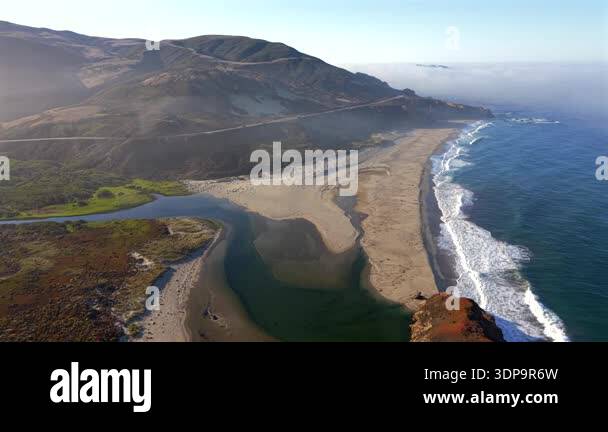 Aerial view of Big Sur California coastline with wide sandy beach and ...
