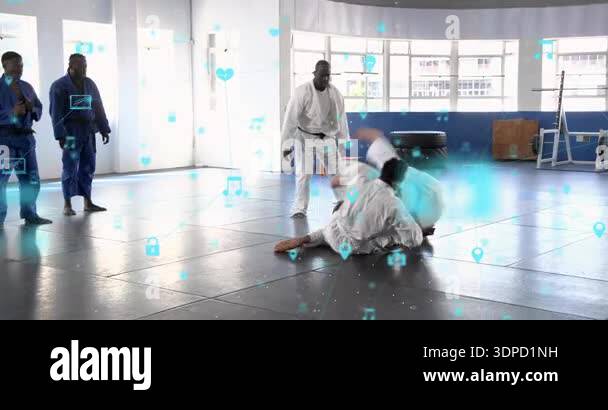 Martial arts coach guiding student from ground hold into mount position ...