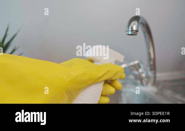 Hand spraying rust and stain remover on metal items, cleaning sink with ...