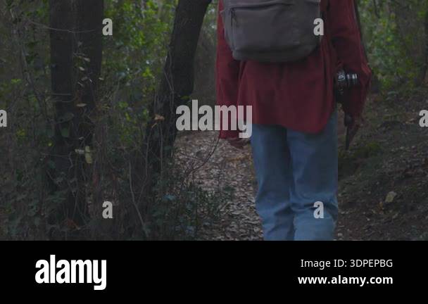 A young woman with a camera on a hike. Creating content for a blog ...