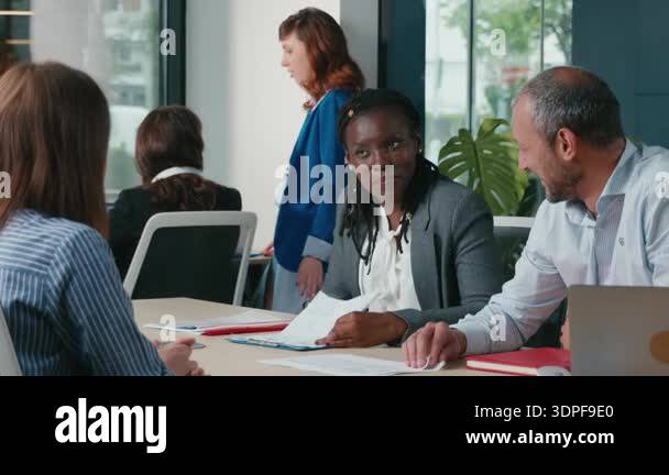 Professional colleagues brainstorming ideas and working together on a ...