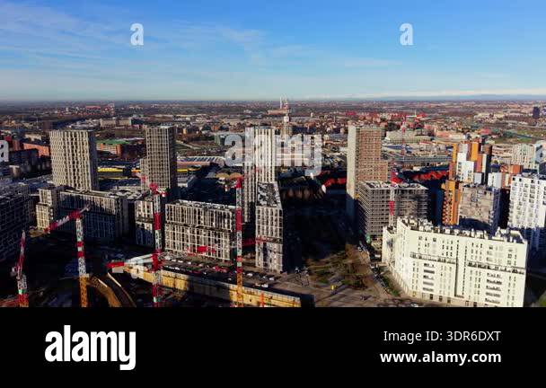 Expansive aerial view of a large construction site with cranes building ...