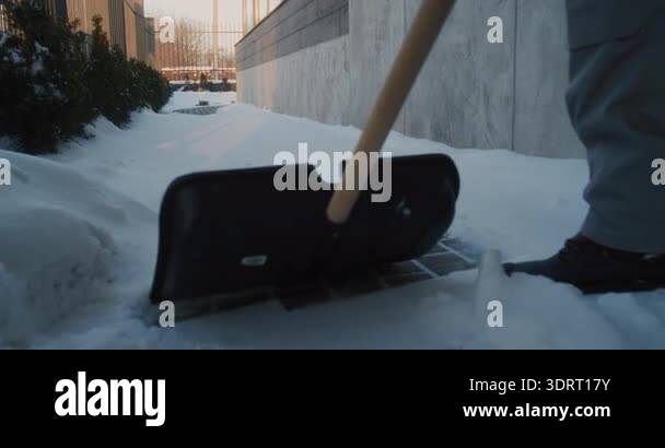 Worker in Winter Uniform Clears Fresh Snow From Narrow Sidewalk Beside ...