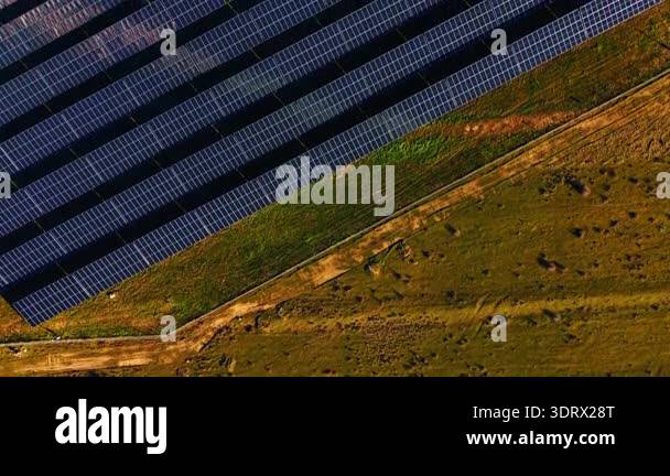 Top down aerial shot of solar panels and field. Vertical high angle ...