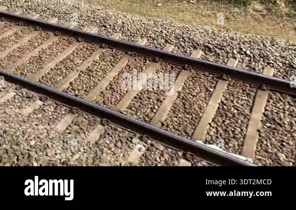 Railway tracks at sunset Steel rails and wooden sleepers on gravel ...