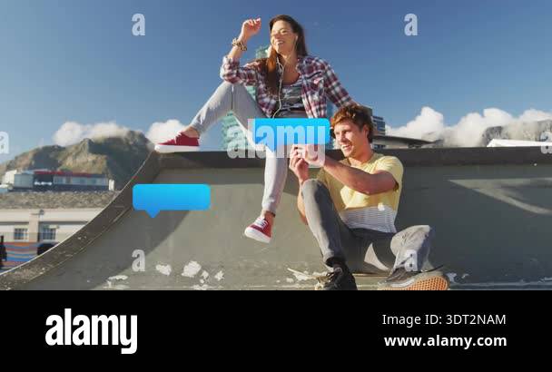 Couple carrying skateboard up ramp and scrolling smartphone social ...