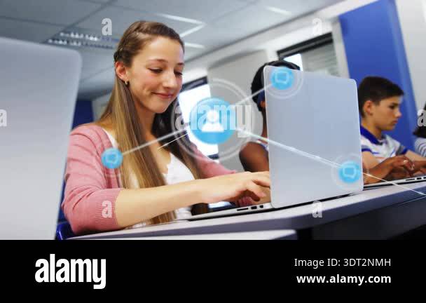 Teenage student typing on laptop in computer lab spawning profile chat ...