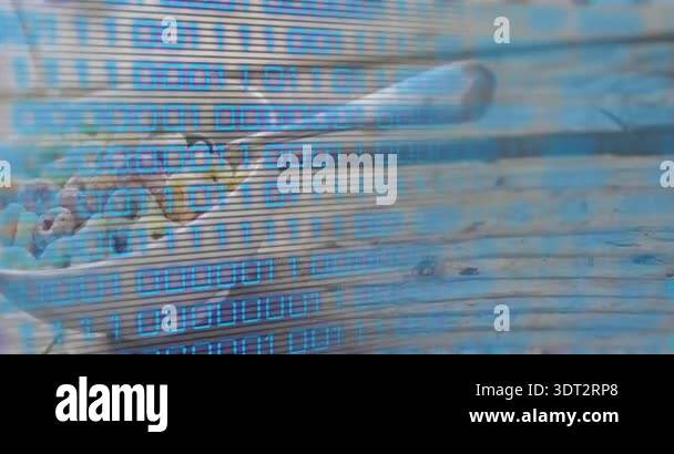 Binary code drifting into view before scrolling across cereal spoon ...