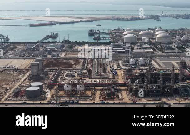 Expansive aerial view of a coastal oil refinery and petrochemical plant ...