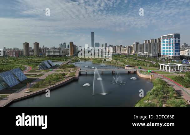Beautiful aerial view of a modern city park with fountains in a river ...