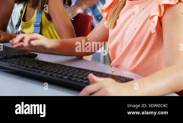 Students typing in computer lab placing hands on keyboards while ...