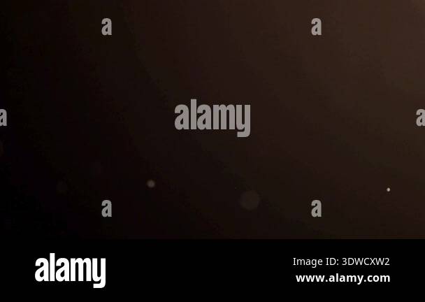 Atmospheric golden light specks and soft bokeh circles floating ...