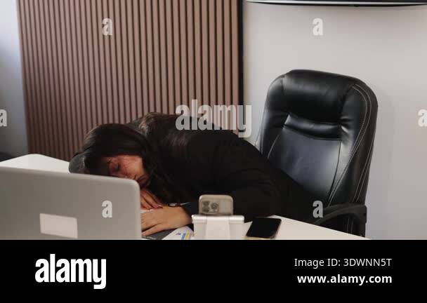 Exhausted female employee napping on her office desk due to overwork ...