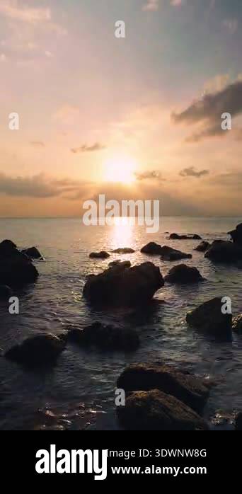 Vertical video. Timelapse Sunset Over Calm Ocean With Dark Coastal ...