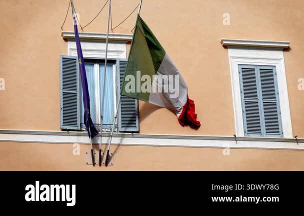 Flags of Italy and the European Union waving together in the wind ...