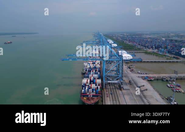 Aerial view of a large container ship docked at Northport terminal with ...