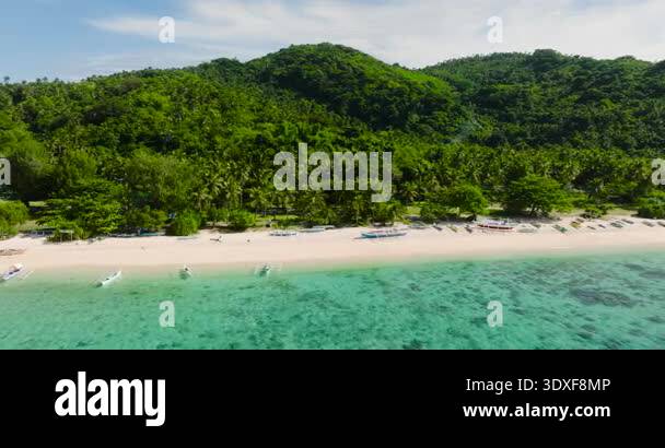 Beautiful beach with white sand and fishing boats. Cobrador Island ...