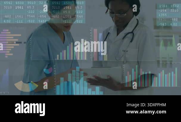 Medical team tapping tablet in hospital reviewing patient data and ...