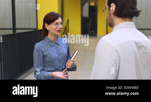 Finalize Discussions Smiling businesswoman greeting male colleague during meeting in office ...