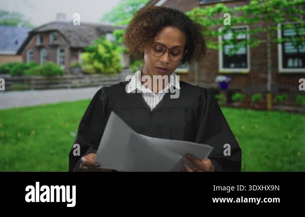 Woman judge reading court papers, hands holding stacked documents at ...
