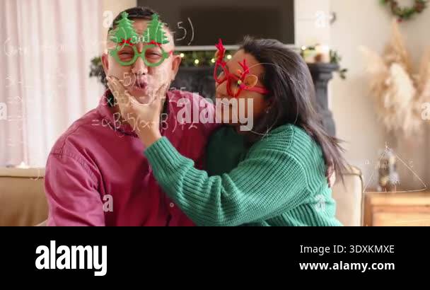 Woman adjusting man tree specs donning antler glasses causing math ...