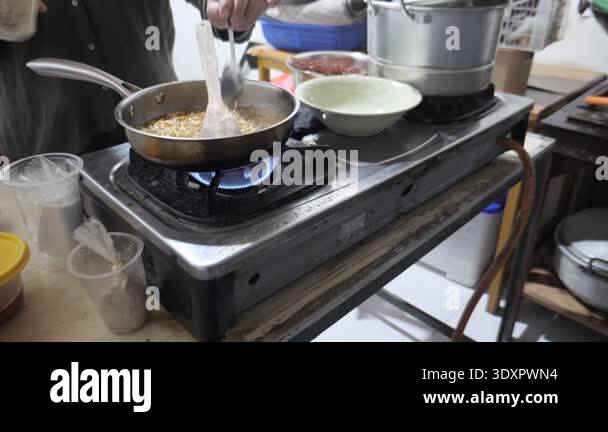 Close up of anonymous woman cooking instant noodles or