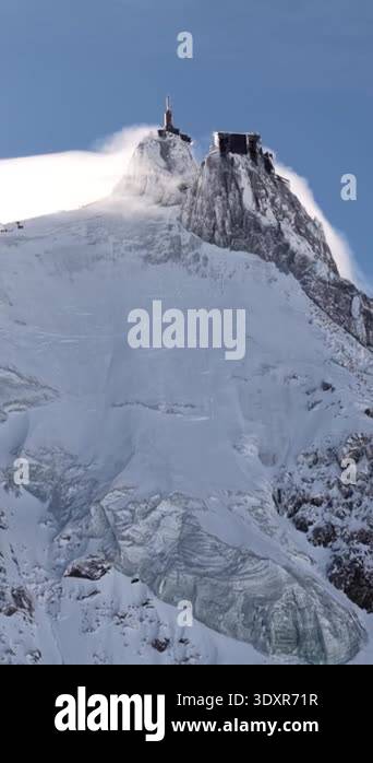 Daytime view of the snowy Aiguille du Midi mountain peak with its ...