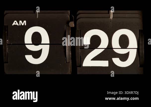 Retro analog mechanical flip clock showing time change from nine twenty ...