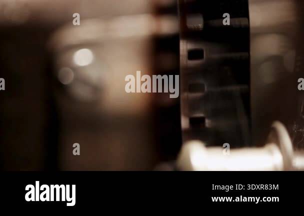 Close up of vintage 35mm film strip running through a movie projector ...