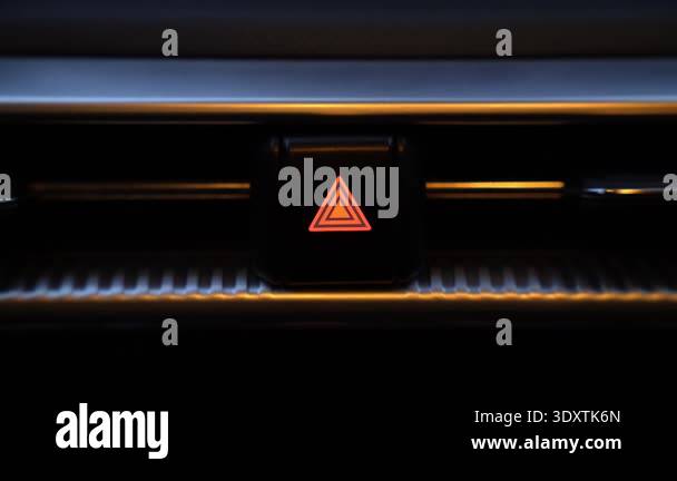 Closeup view of hazard lights button blinking on car dashboard ...