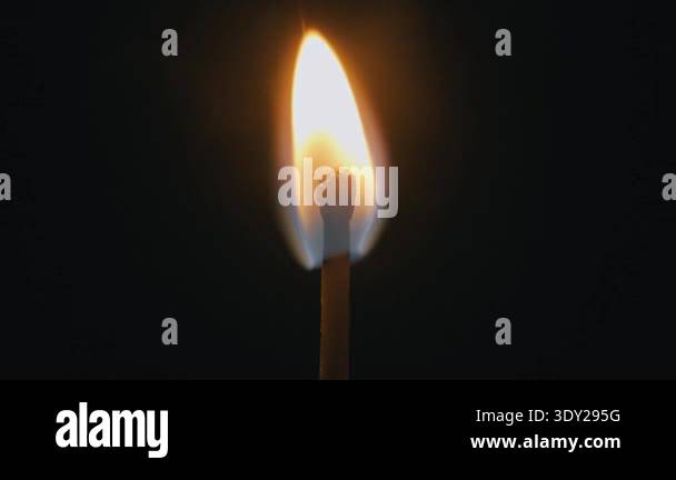 Single matchstick ignites with a burst of fire and burns with a steady ...