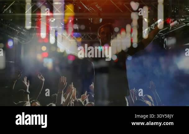 Concert performer diving into crowd, crowd-surfing under pulsing LED ...