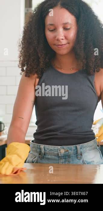 A content young woman with beautiful natural curly hair diligently ...