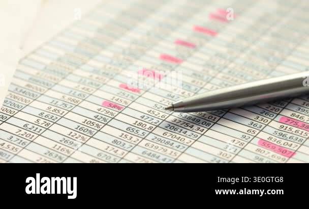 Pen lies on table with digits underlined in different colors to ...