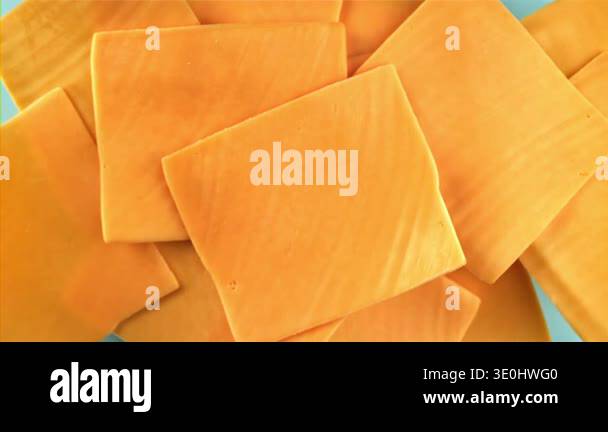 Sliced cheddar cheese fly and fall. Filmed on a high-speed camera at ...