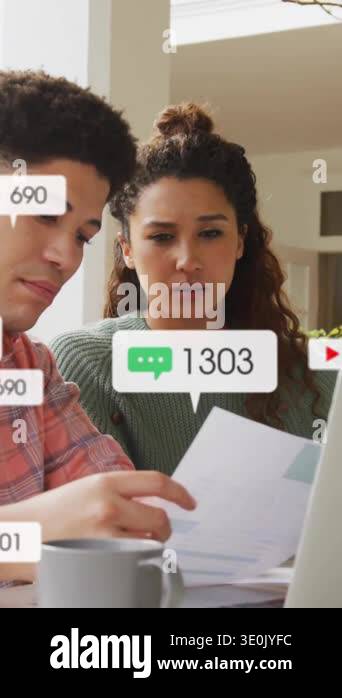 Social media engagement animation over people working on laptops at ...