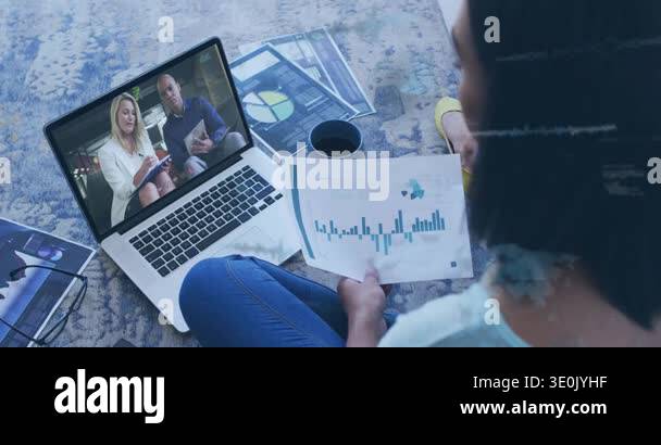 Seated woman adjusting bar chart on rug for business as laptop team ...