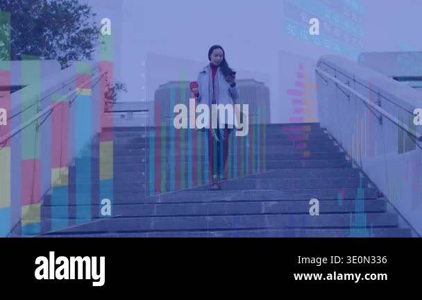 Woman checking phone and taking business call while walking stairs with ...