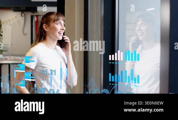 Woman standing by glass, speaking on phone, call causing business ...