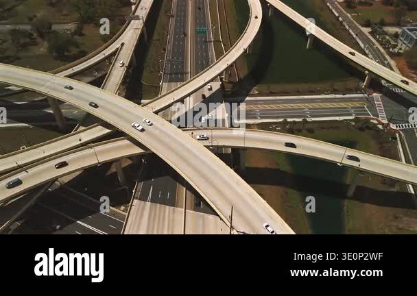 Close aerial freeway interchange with curved overpasses and traffic ...
