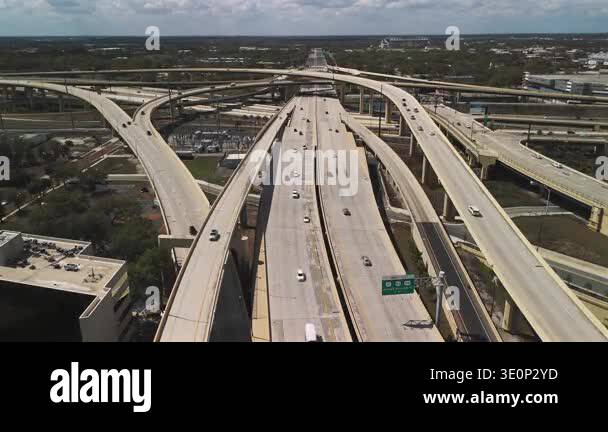 Freeway interchange with elevated ramps and moving traffic aerial Stock ...