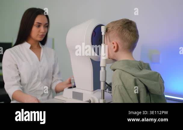 Female optometrist performing a visual acuity test on a young patient ...
