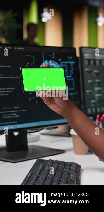 Vertical video Green screen mockup phone used by programmer typing code ...
