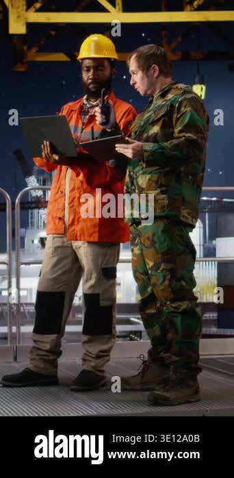 Security Guard Rig Vertical Video Naval officer and engineer using walkie talkie on oil ...