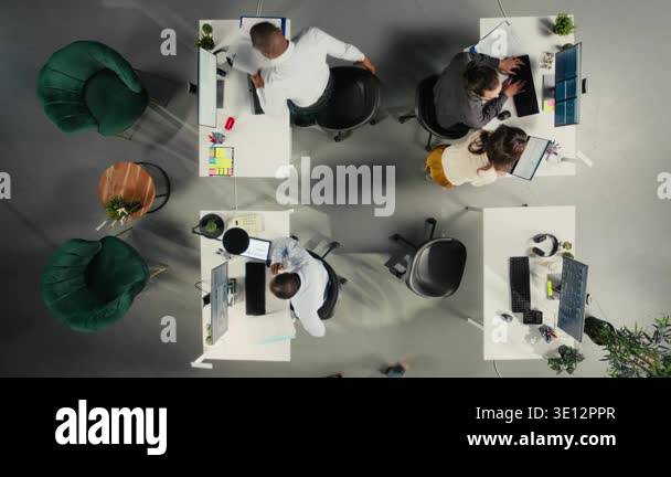 Top down view of diverse business staff gathered for briefing in ...