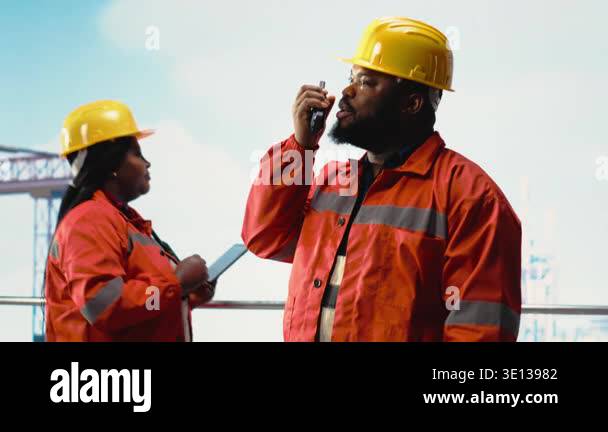 Employee Using Radio Offshore platform worker speaking in walkie talkie, scheduling ...