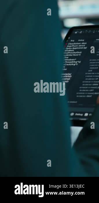 Vertical video Close up of data center programmer using tablet app to ...