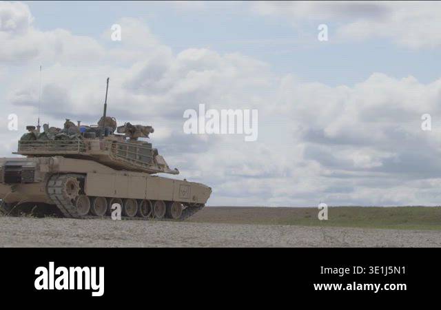 USA - 7.31.2025 - Ground level rear view of an M1 Abrams tank firing ...