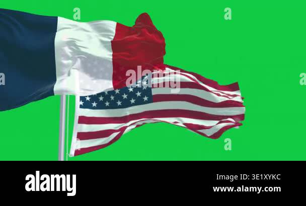 National flags of France and USA waving in the wind isolated on green ...